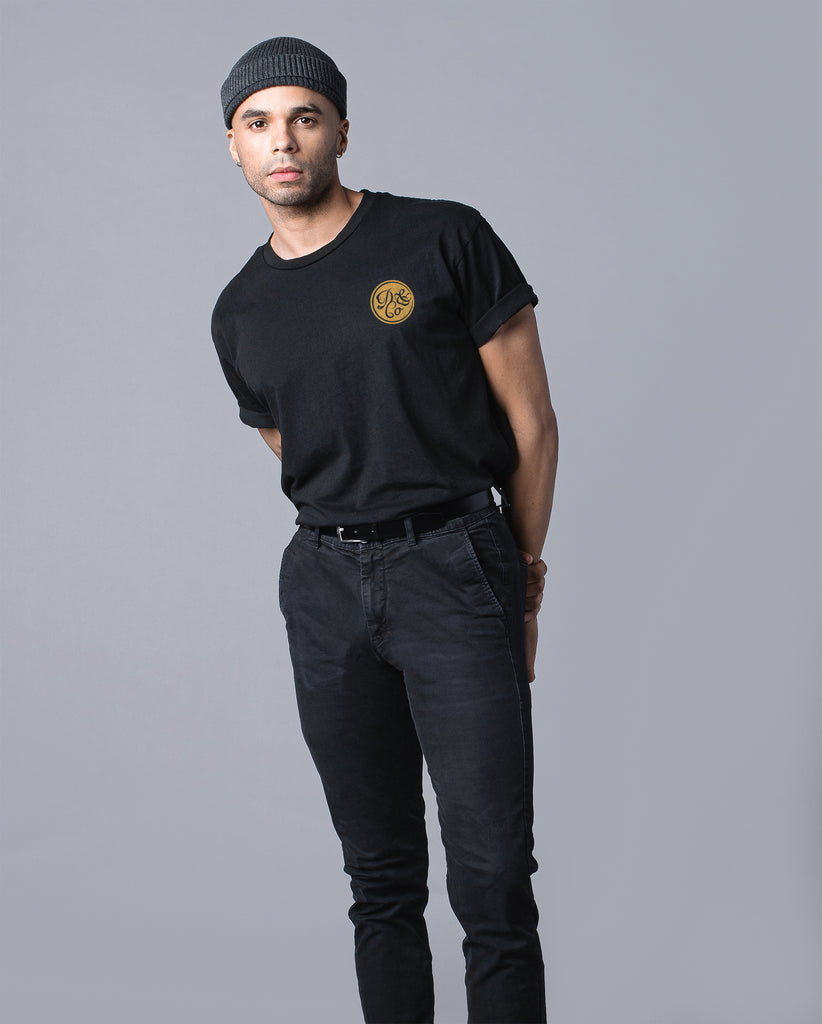 front of man wearing black t-shirt with death & co. logo on pocket 
