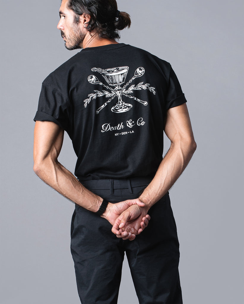 back of man wearing black t-shirt with death & co. crest