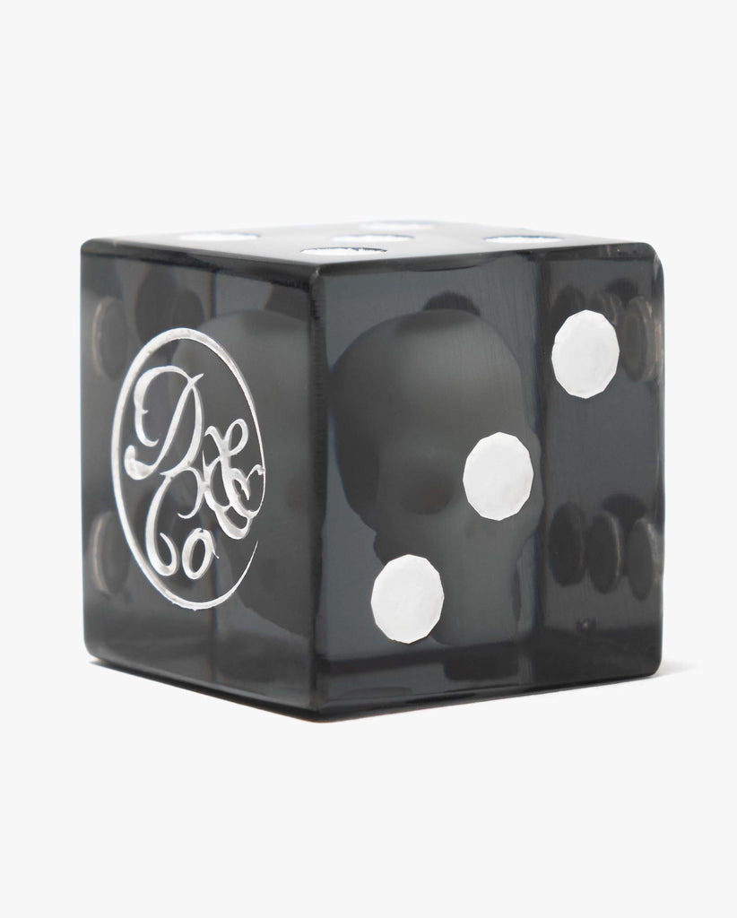 close up of Death & Co. x Death Rattle dice with suspended skull inside