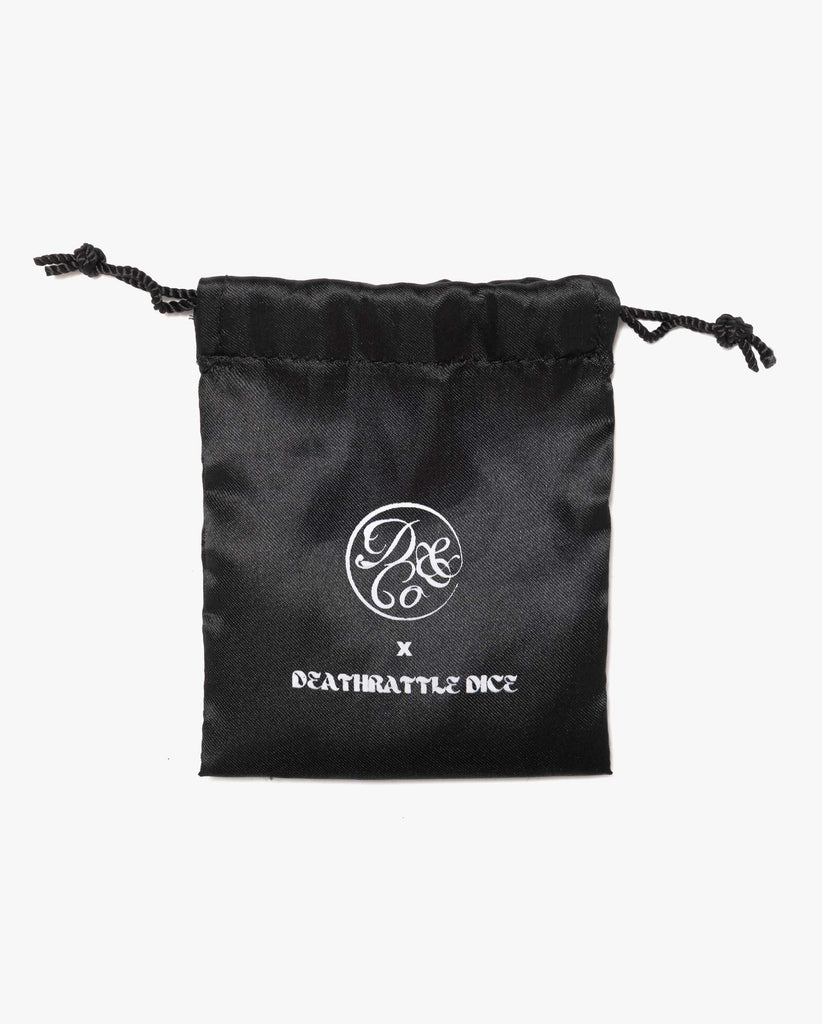 black satin bag with death & co. logo and death rattle dice logo