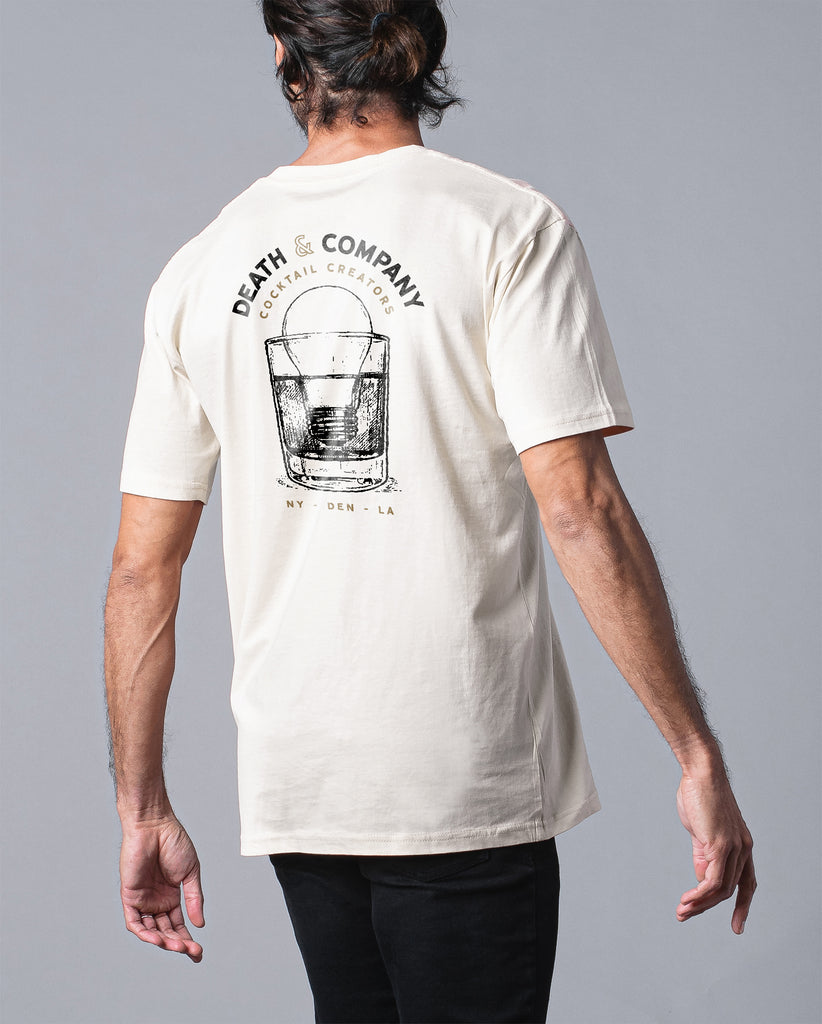 back of man wearing white t-shirt "death & company cocktail creators" with light bulb in drink design 