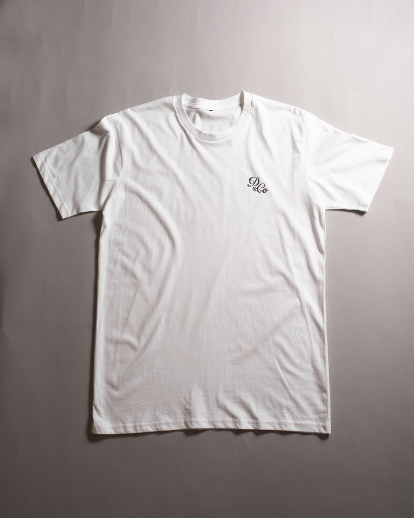 white t-shirt laid out with death & co. logo on pocket