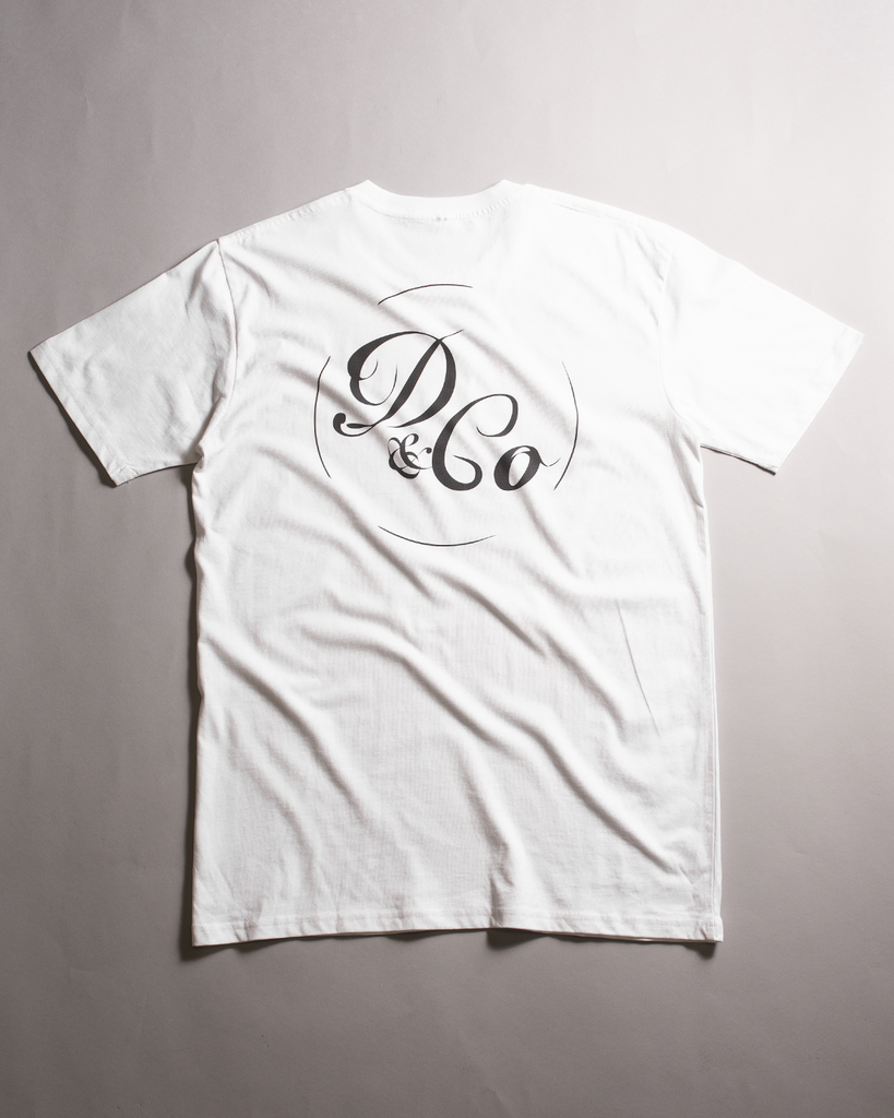 white t-shirt laid out with death & co. in circle design