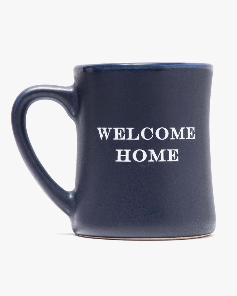 navy mug with "welcome home" on it
