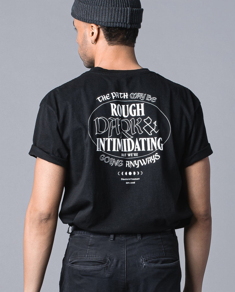 back of man wearing black Rough, Dark, & Intimidating tee