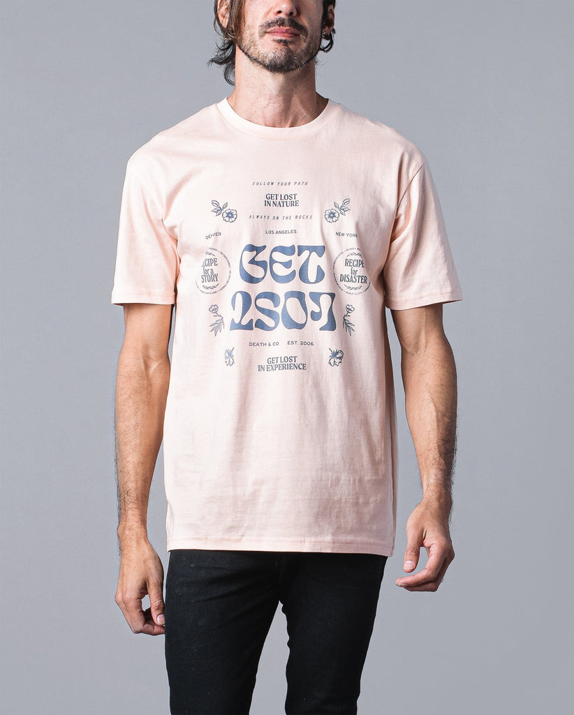 man wearing peach get lost tee