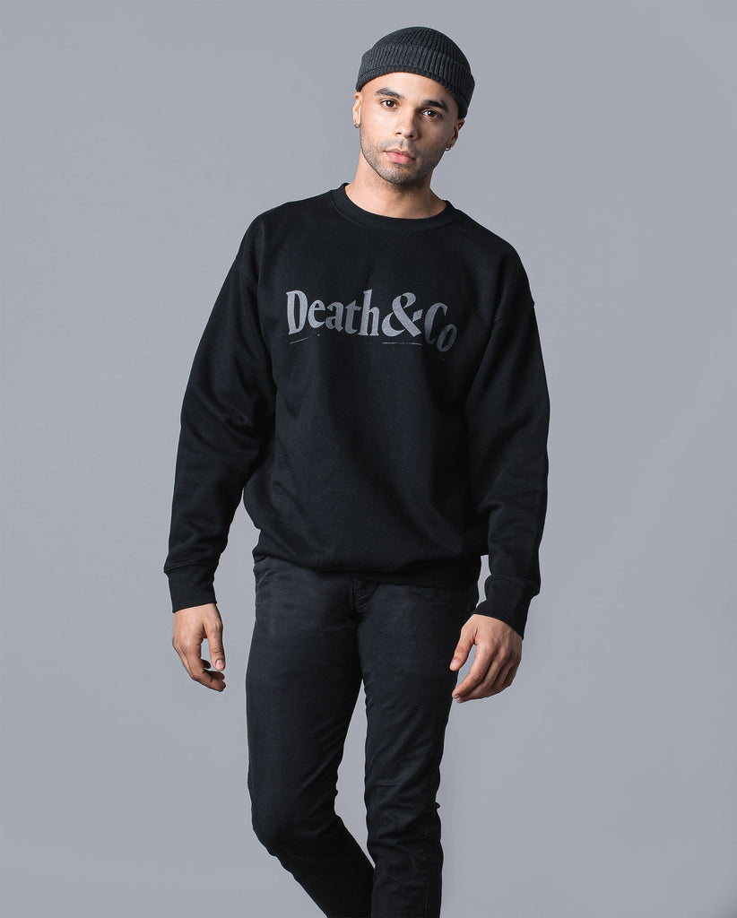 man wearing black crew fleece with "death & co" across chest