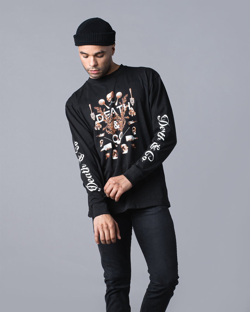 man wearing black obituary long sleeve with "death & co." on sleeves