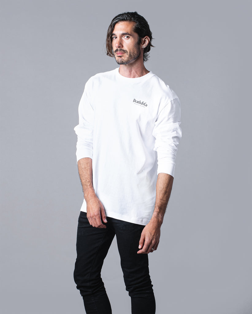 front of man wearing white long sleeve with death & co. on pocket